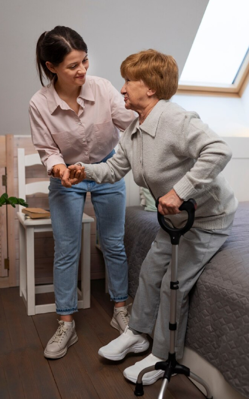 Support worker helping elderly woman walk safely – reliable Personal Care Services Campbellfield and Assistance with Personal Care for NDIS participants.